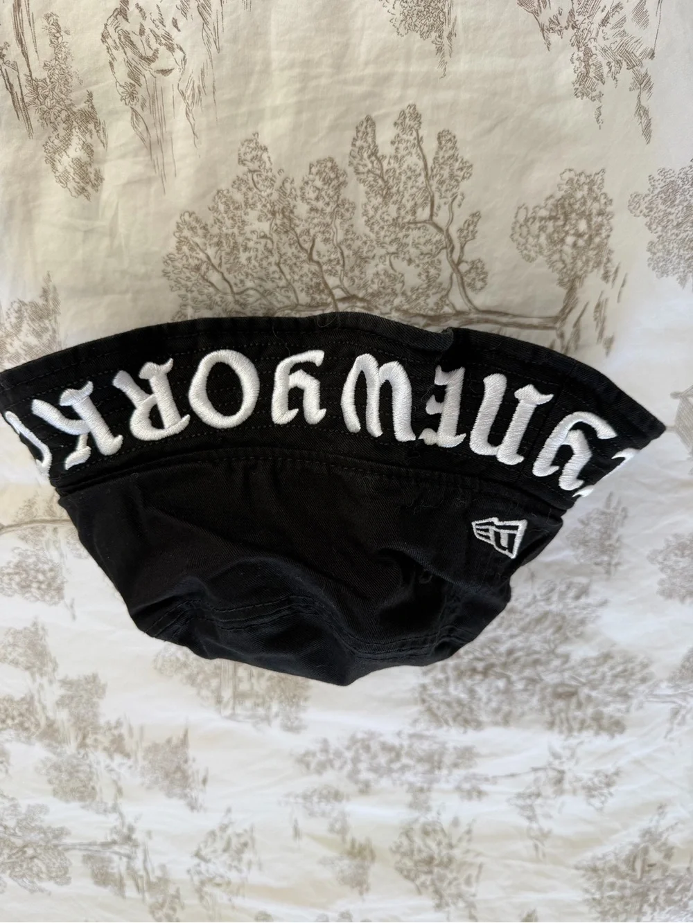 New Era Black Bucket Hat with White Embroidered Lettering